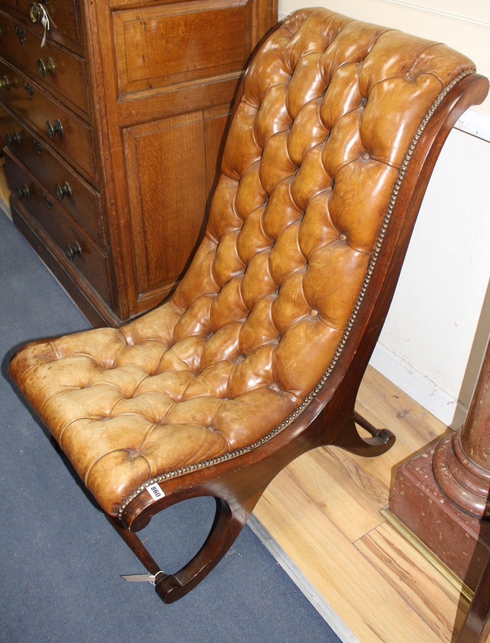 A Regency style library chair with buttoned leather upholstery, W.54cm D.84cm H.100cm